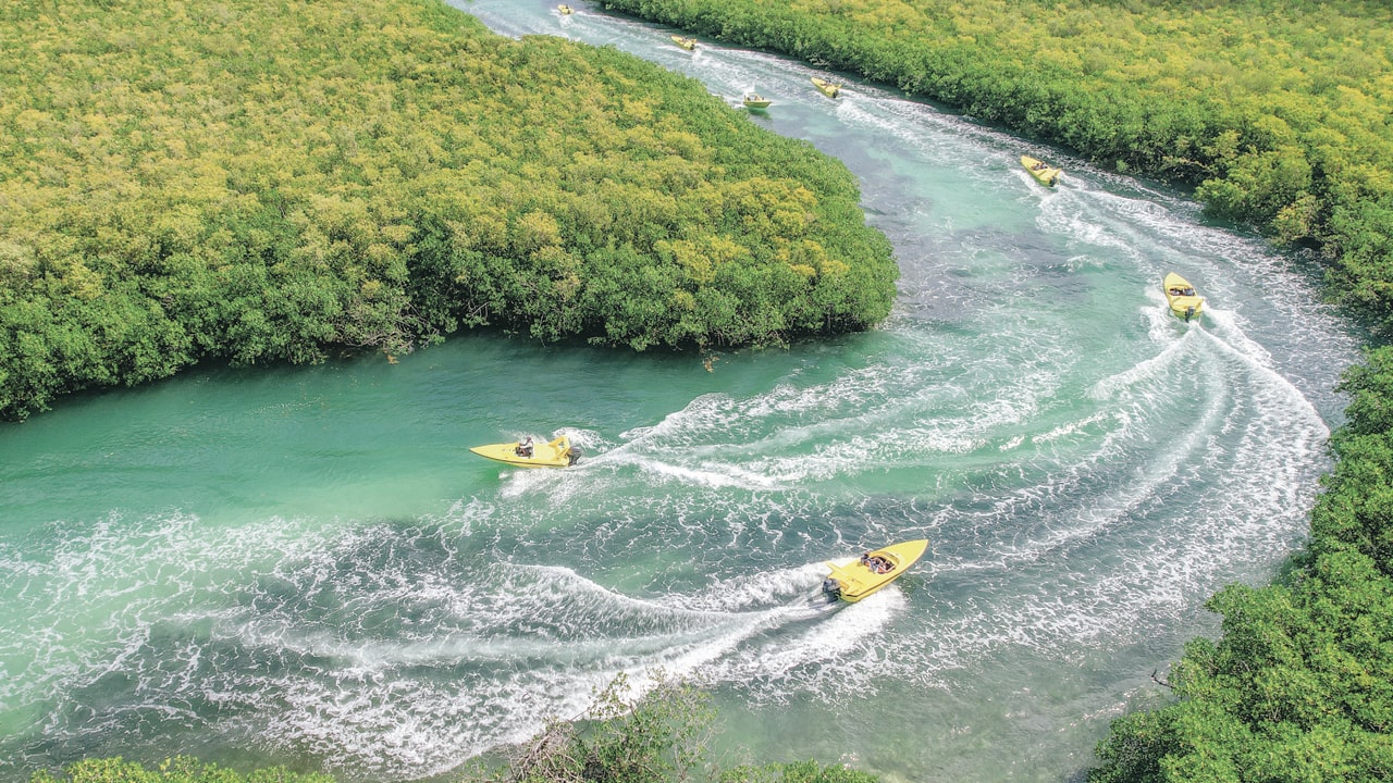 Speedboats crossing Cancun mangrove channels